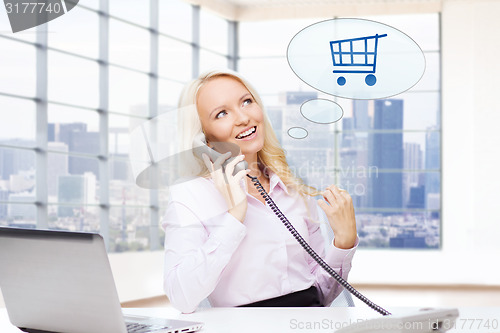Image of smiling businesswoman calling on telephone