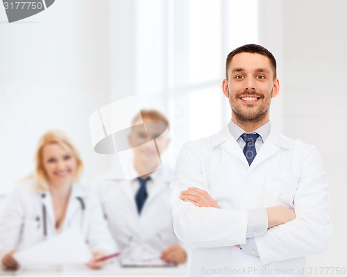 Image of smiling male doctor in white coat