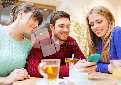 Image of group of friends with smartphone meeting at cafe