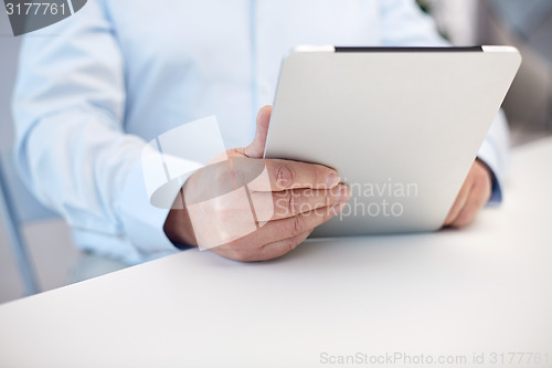 Image of close up of senior man hands with tablet pc