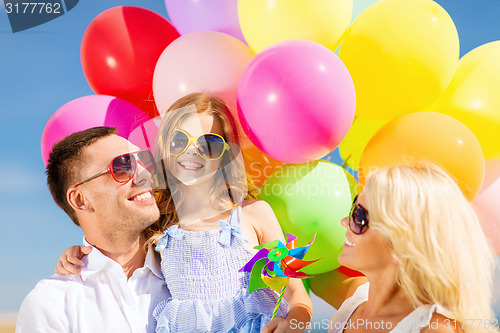 Image of family with colorful balloons