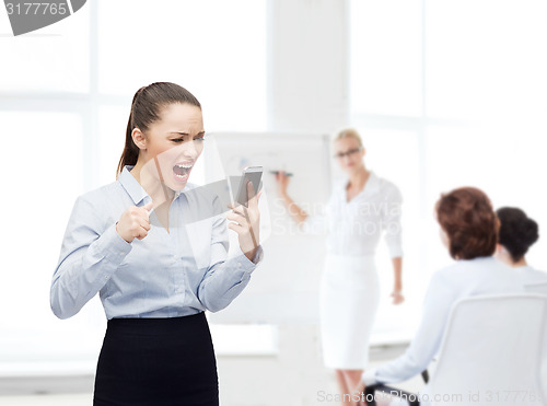 Image of screaming businesswoman with smartphone