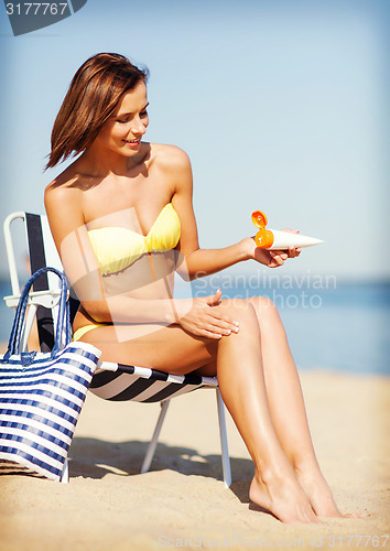 Image of girl sunbathing on the beach chair