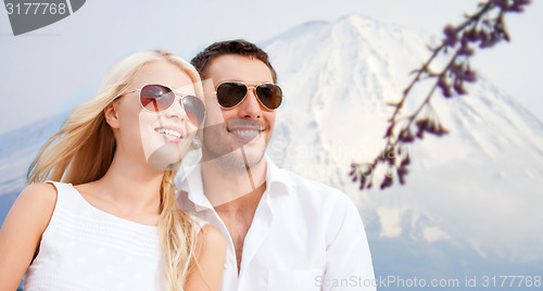 Image of couple in shades at sea side