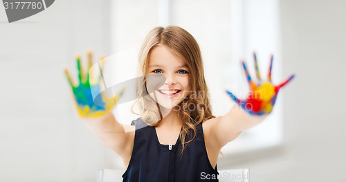 Image of girl showing painted hands