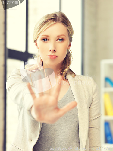 Image of young woman making stop gesture