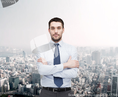 Image of handsome businessman with crossed arms