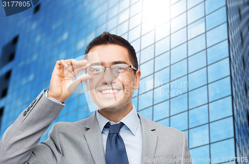 Image of happy smiling businessman in eyeglasses and suit