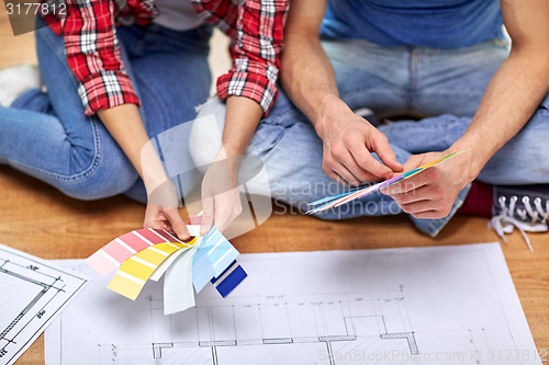 Image of close up of couple with blueprint and samples