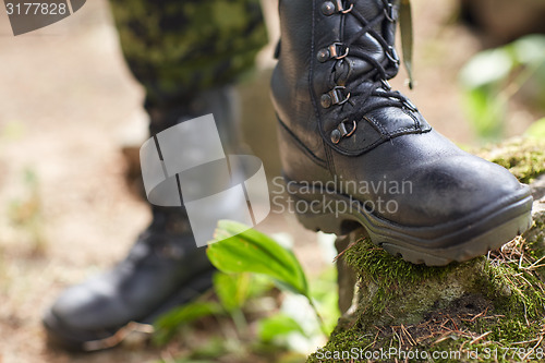 Image of close up of soldier feet with army boots in forest