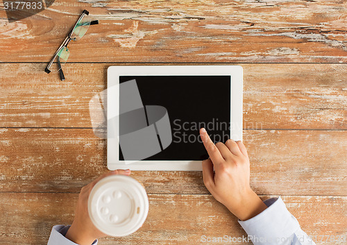 Image of close up of female hands with tablet pc and coffee