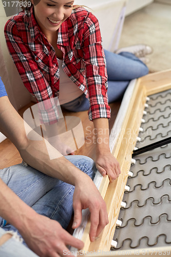 Image of close up of couple assembling furniture at home