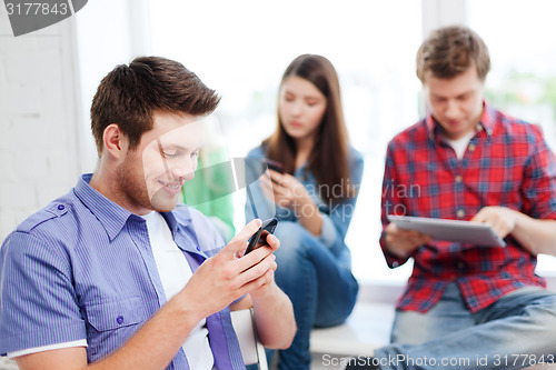 Image of student looking into smartphone at school