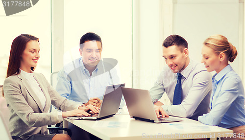 Image of business team working with laptop in office