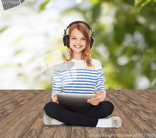 Image of happy girl with headphones and tablet pc