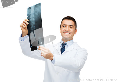 Image of smiling male doctor in white coat holding x-ray