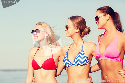 Image of group of smiling young women in sunglasses