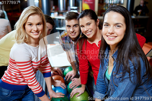 Image of happy friends in bowling club