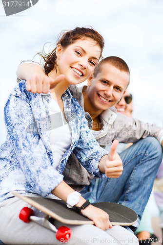 Image of teenages with skateboard outside