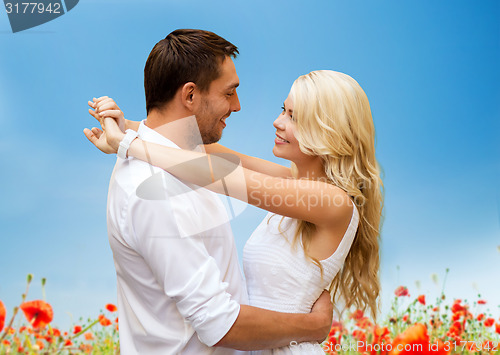 Image of happy couple hugging over natural background