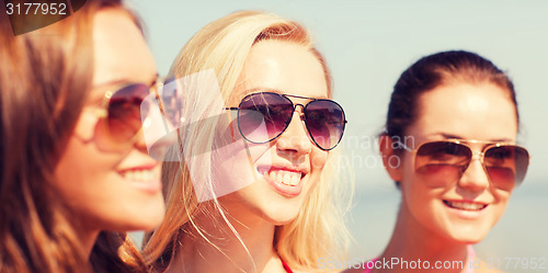 Image of close up of smiling young women in sunglasses