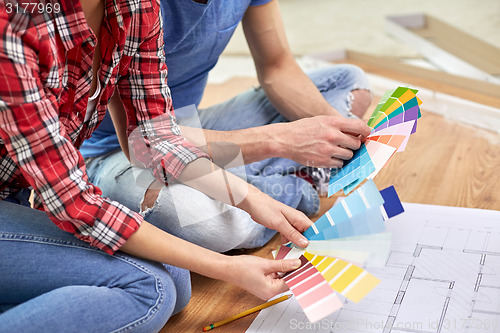 Image of close up of couple with blueprint and palettes