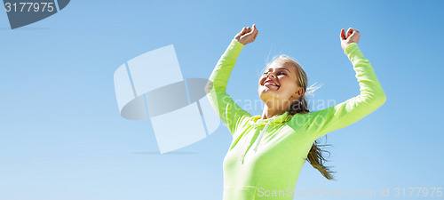 Image of woman runner celebrating victory