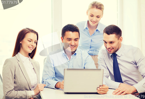 Image of business team working with laptop in office