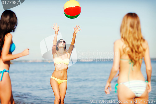 Image of girls with ball on the beach