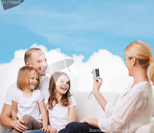 Image of happy family with camera at home