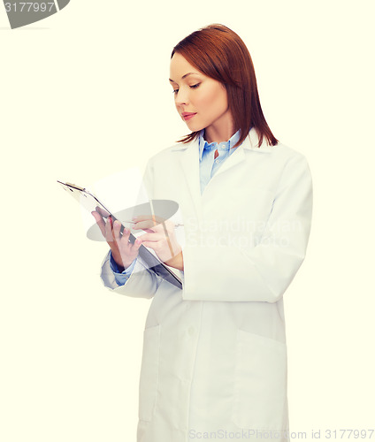 Image of smiling female doctor with clipboard