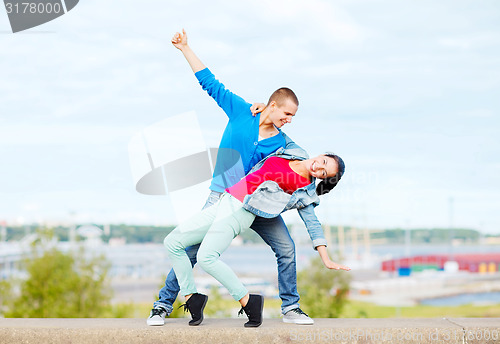 Image of couple of teenagers dancing outside