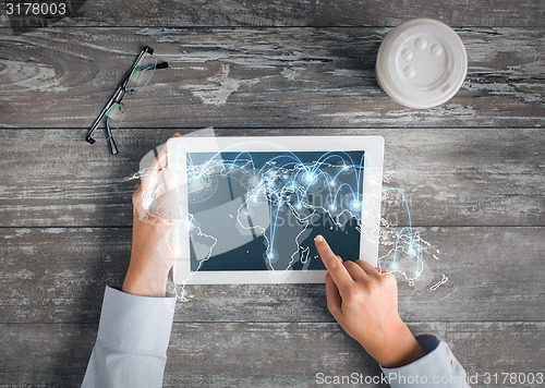 Image of close up of hands with tablet pc and network