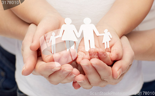 Image of close up of woman and girl hands with paper family