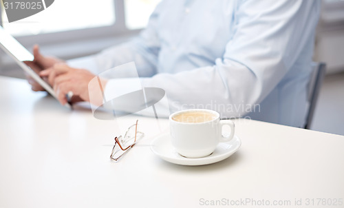 Image of close up of senior man hands with tablet pc