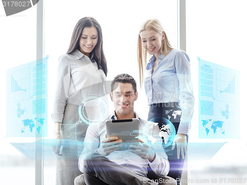 Image of business team working with tablet pc in office