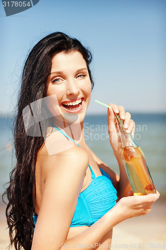 Image of girl with bottle of drink on the beach