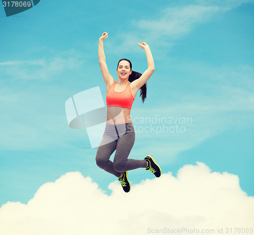 Image of sporty teenage girl jumping in sportswear