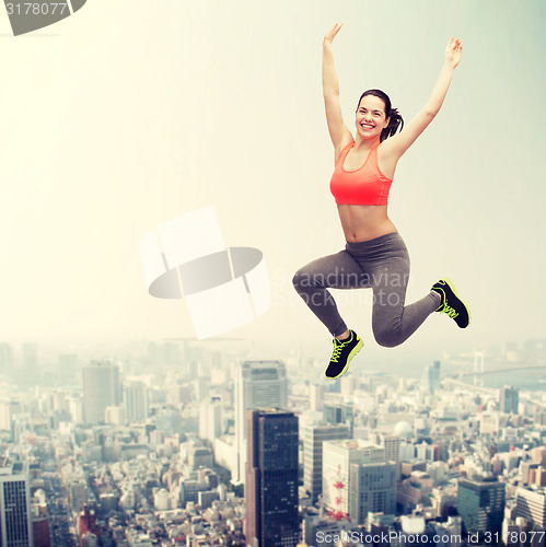 Image of sporty teenage girl jumping in sportswear