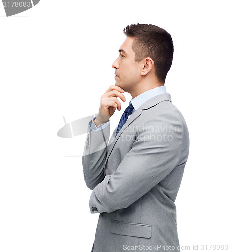 Image of thinking businessman in suit making decision