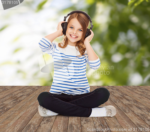 Image of happy girl with headphones listening to music