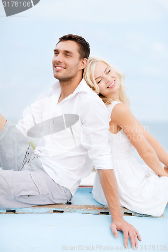 Image of couple in shades at sea side