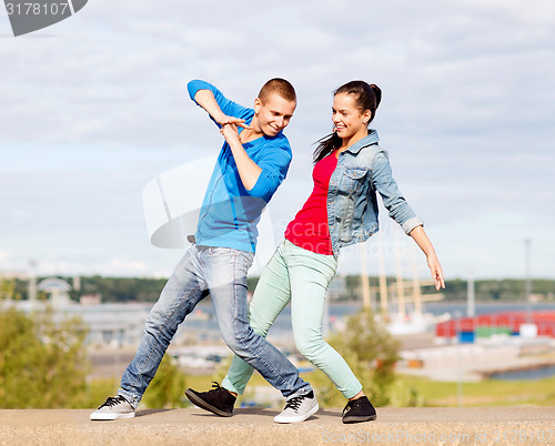 Image of couple of teenagers dancing outside