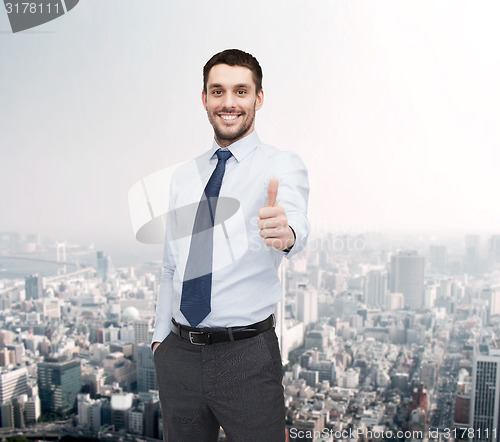 Image of handsome businessman showing thumbs up