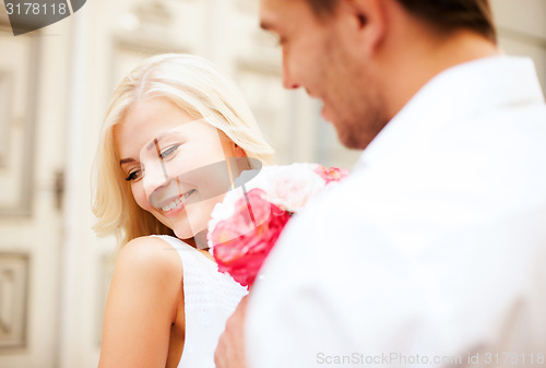 Image of couple with flowers in the city