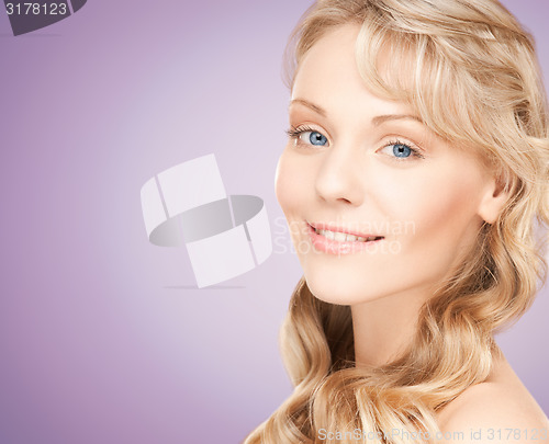 Image of beautiful young woman face with long wavy hair