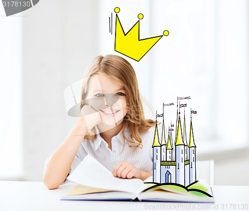 Image of smiling girl reading fairytales at home