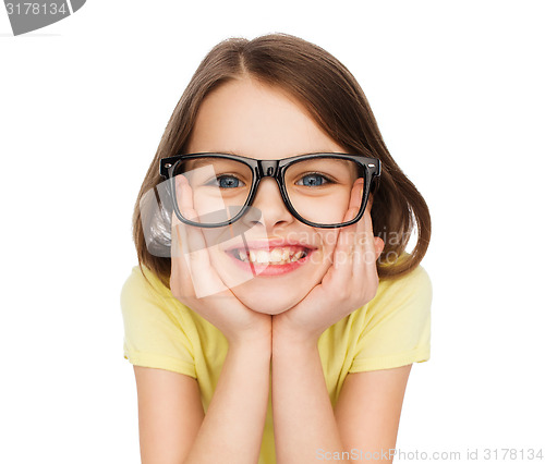 Image of smiling cute little girl in black eyeglasses