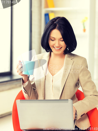 Image of happy woman with laptop computer