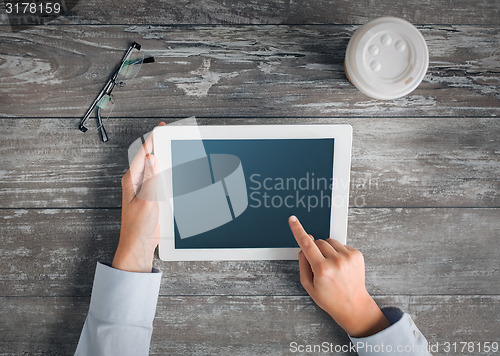 Image of close up of hands with tablet pc and coffee